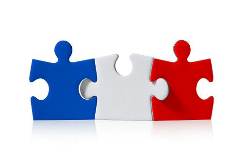 Three puzzle pieces make up the French flag isolated on white background. Photo with clipping path.