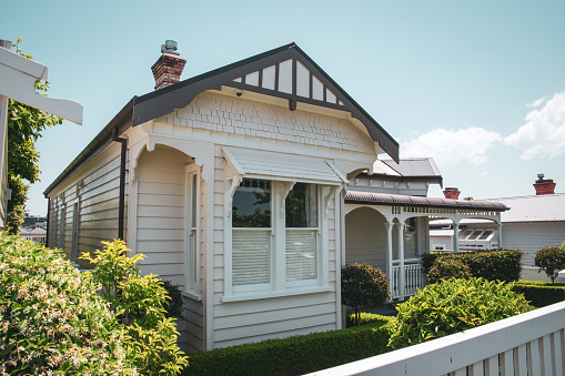 Auckland, New Zealand – December 04, 2019: View of typical white wooden colonial villa in Remuera. Vintage look. Auckland, New Zealand - December 4 2019