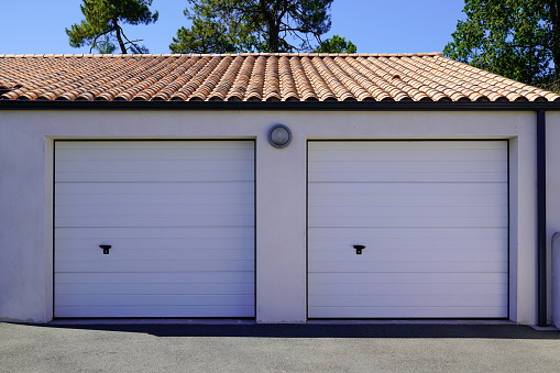 garage double sectional gate closed two white door on private residential house