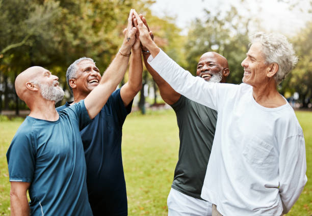 High five, fitness and senior men friends in park for teamwork, exercise target and workout mission together with community support. Elderly group of people with outdoor wellness success hands sign High five, fitness and senior men friends in park for teamwork, exercise target and workout mission together with community support. Elderly group of people with outdoor wellness success hands sign happiness four people cheerful senior adult stock pictures, royalty-free photos & images