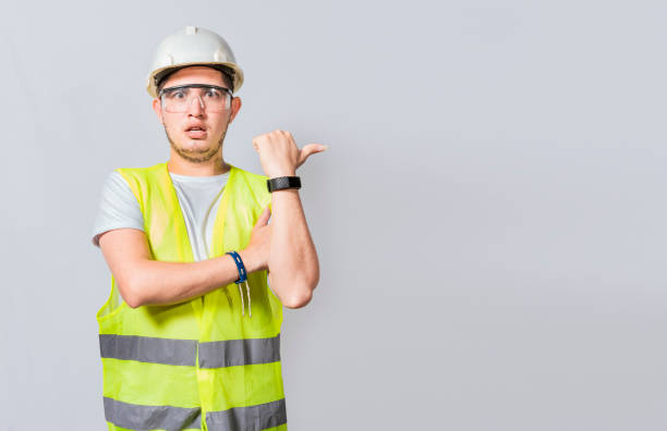 istock Amazed Engineer pointing to side. Surprised engineer pointing finger to the right, Surprised engineer pointing to the side, Surprised face construction worker pointing at an advertisement 1442432752