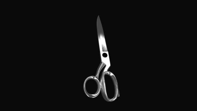 Scissors spinning on black background