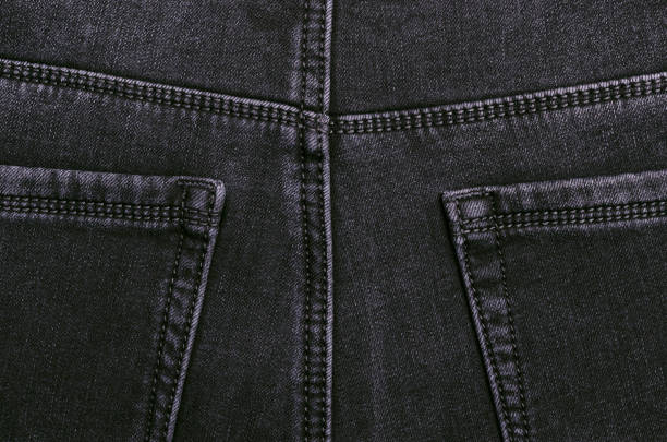 Part of dark jeans. Textile texture. Design concept. Top view.