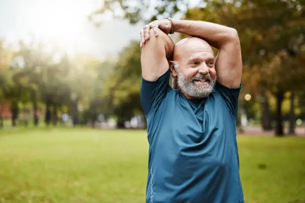 Photo of Stretching, fitness and running with old man in park for health, workout or sports with mockup. Warm up, retirement and exercise with senior runner in nature for training, jogger and cardio endurance