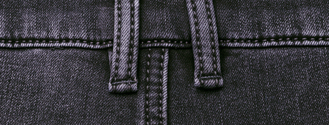 Part of dark jeans.  Textile texture. Design concept. Top view.