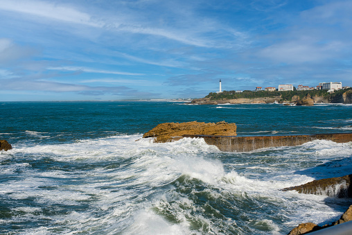 Biarritz beach at high tide with its lighthouse on the horizon
