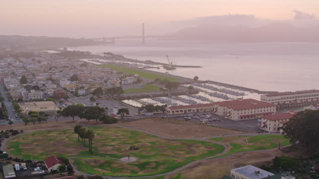 AERIAL Fort Mason, San Francisco with Golden Gate Bridge in the background at dusk