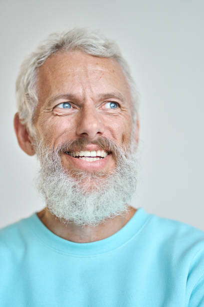 istock Smiling senior old man looking away dreaming isolated on white. Vertical closeup 1442437997