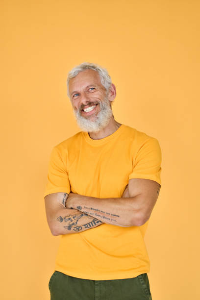 istock Smiling older bearded hipster man isolated on yellow background, portrait. 1442438071