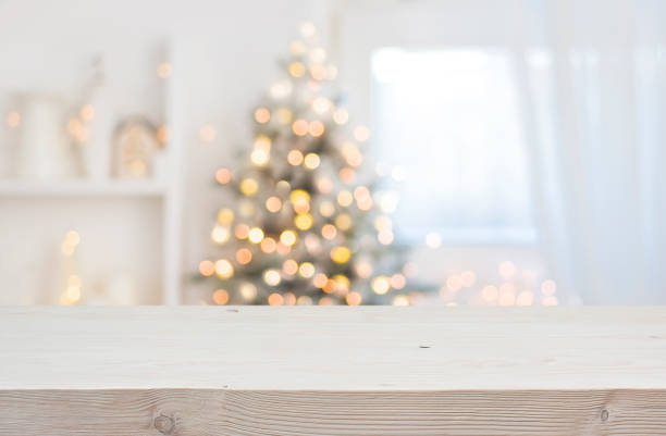 istock Wooden table in front of abstract blurred Christmas decorations background 1442440006