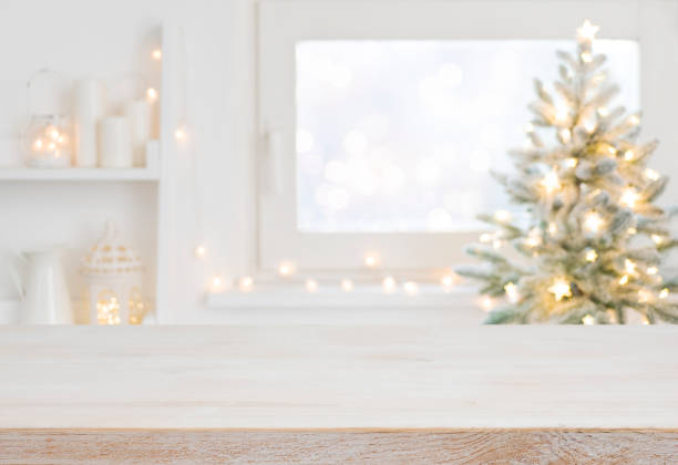 Empty table in front of christmas tree with decoration background stock photo
