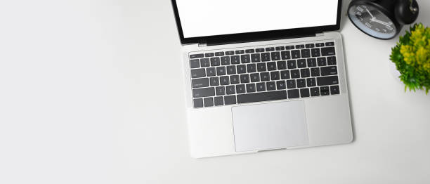 istock Top view office table with laptop computer and alarm clock 1442443898
