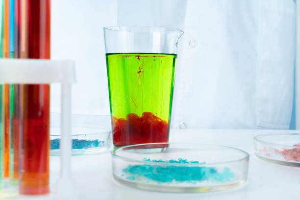 istock Manipulations with laboratory glass chemical containers on table 1442445743