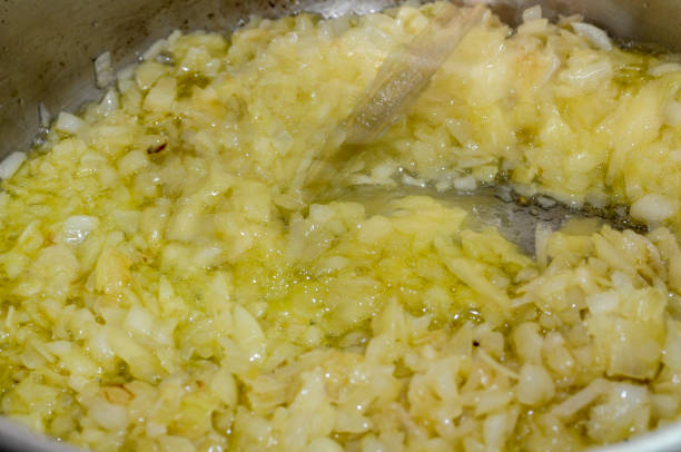 Cooking onion in olive oil. Caramelized onion.