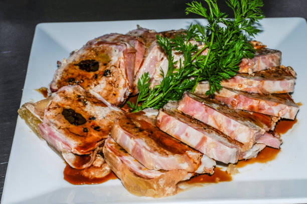 istock Rolled meatloaf with sauce, presented in slices on a white plate. 1442448770
