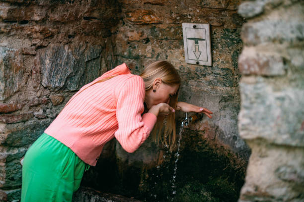 istock A Woman Drinking Water at the Holy Spring 1442448814