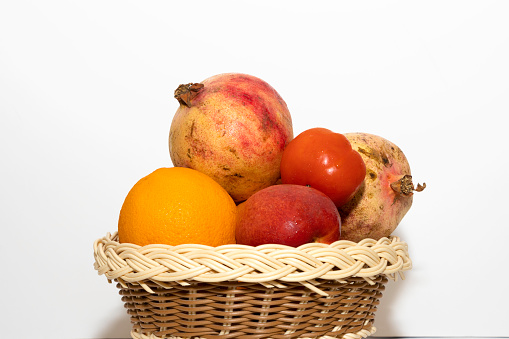 Closeup Image Of Fresh Fruits In Basket In White Background