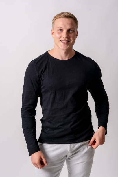 istock Attractive blond german model with black sweater on a white background, looking at camera smiling 1442453876