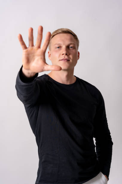 istock Attractive blonde german model in a black jersey on a white background, stop racism, stop homophobia 1442453877