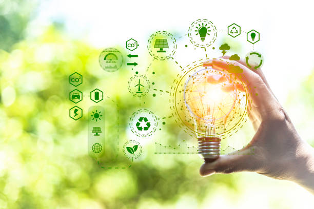 istock green energy concept help reduce global warming.Hand holding natural background light bulb on green leaf with clean energy icon around it. Carbon dioxide emission in industry zero carbon concept. 1442454316