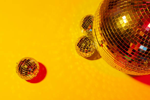istock Shiny party disco balls shining in a day light over color background 1442469375