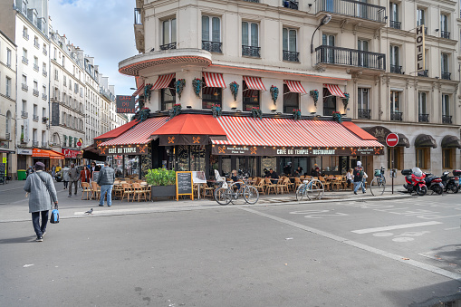 Paris, France - May 10, 2019: Rainy evening in Paris with no people outside and empty sidewalk cafe.