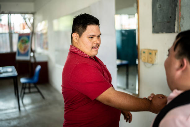istock Young special needs students greeting when arriving in the classroom at school 1442473799