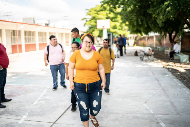 istock Young special needs arriving with their friends at school 1442474103