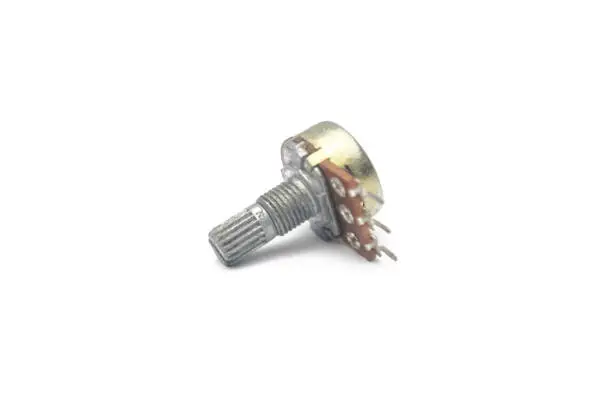 Photo of Close-up view of a potentiometer or variable resistor for adjusting or changing conditions on a mixer on a white background.