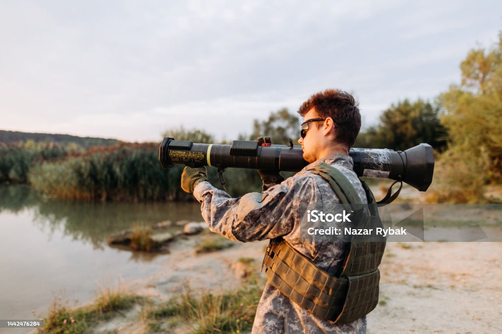 The male soldier using anti tank weapon to hit the target The male special forces soldier using anti tank weapon AT4 to hit the target during the conflict Adults Only Stock Photo