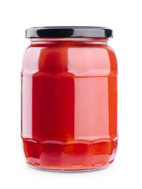 istock Tasty ketchup in glass jar isolated on white 1442476532