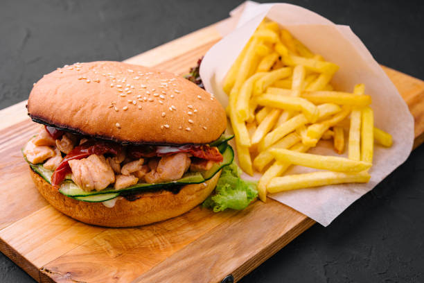 istock Burger with fries on wooden rustic Board 1442476667