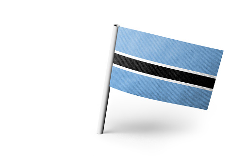 Small paper flag of Botswana pinned. Isolated on white background. Horizontal orientation. Close up photography. Copy space.