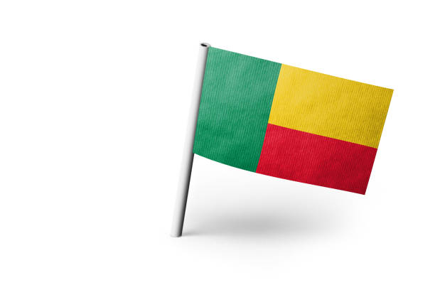 Small paper flag of Benin pinned. Isolated on white background. Horizontal orientation. Close up photography. Copy space.