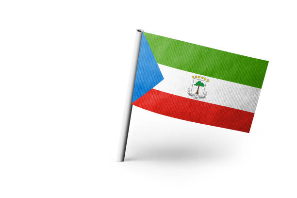 Small paper flag of Equatorial Guinea pinned. Isolated on white background. Horizontal orientation. Close up photography. Copy space.