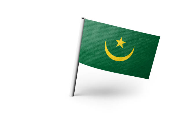 Small paper flag of Mauritania pinned. Isolated on white background. Horizontal orientation. Close up photography. Copy space.
