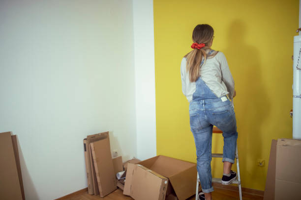 istock An unrecognizable woman drives a nail into the wall 1442478205