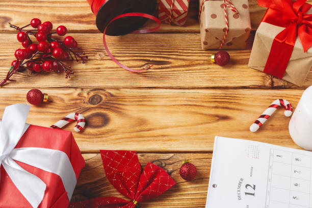 istock Christmas wrapping and decorating items on wooden background with copy space 1442478713