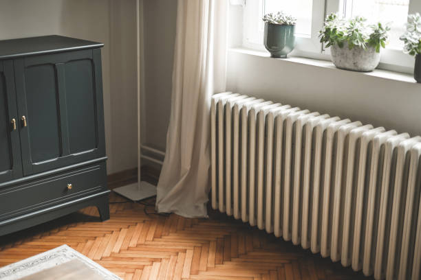 heating radiator in home room stock photo
