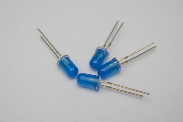 istock Close-up view of four blue LED (Light Emitting Diode) components on a gray background. 1442479959