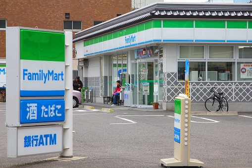 People visit FamilyMart convenience store in Matsumoto city, Japan.  FamilyMart is one of largest convenience store franchise chains in Japan.