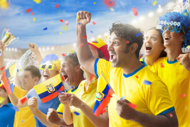 Ecuador football supporter on stadium. Ecuadorian fans on soccer pitch watching team play. Group of supporters with flag and national jersey cheering for Ecuador. Championship game.