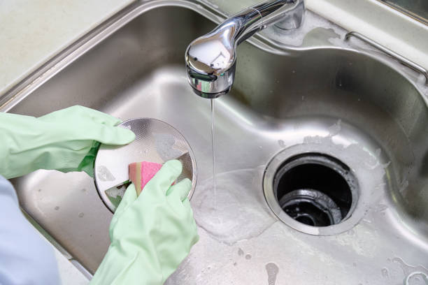 istock Women cleaning the kitchen sink with sponge 1442482458