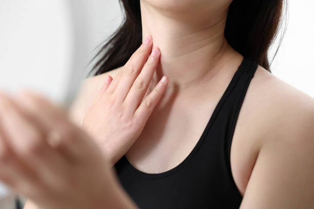 neck wrinkles A woman looking in the mirror while touching her neck wrinkles wrinkled stock pictures, royalty-free photos & images