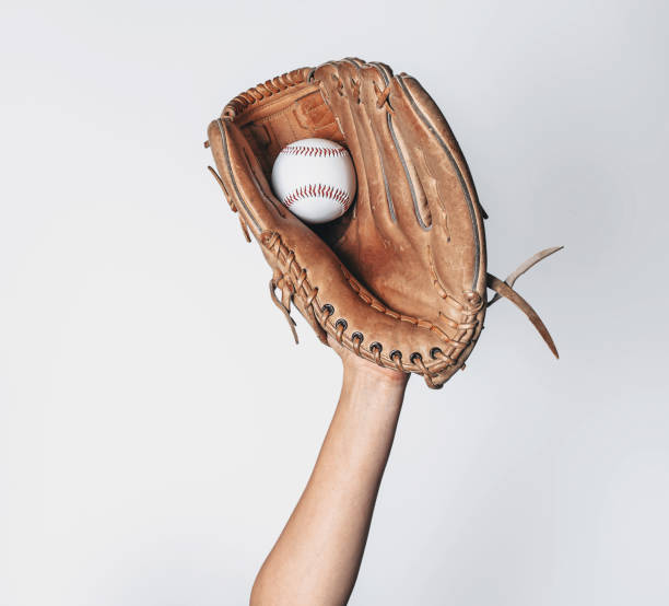 istock Baseball is caught in a worn baseball glove. 1442482979