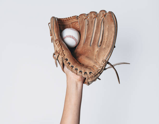 istock Baseball is caught in a worn baseball glove. 1442482990