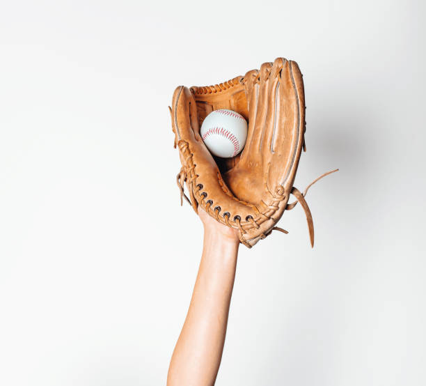 istock Baseball is caught in a worn baseball glove. 1442483039