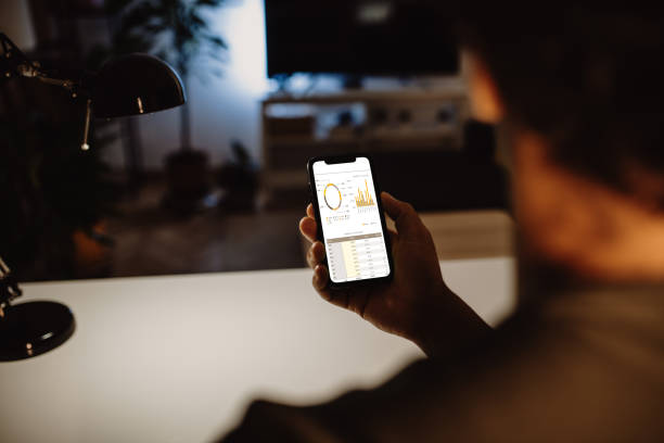 istock Unrecognisable African man holding phone and dealing with finances as seen on device screen 1442483746