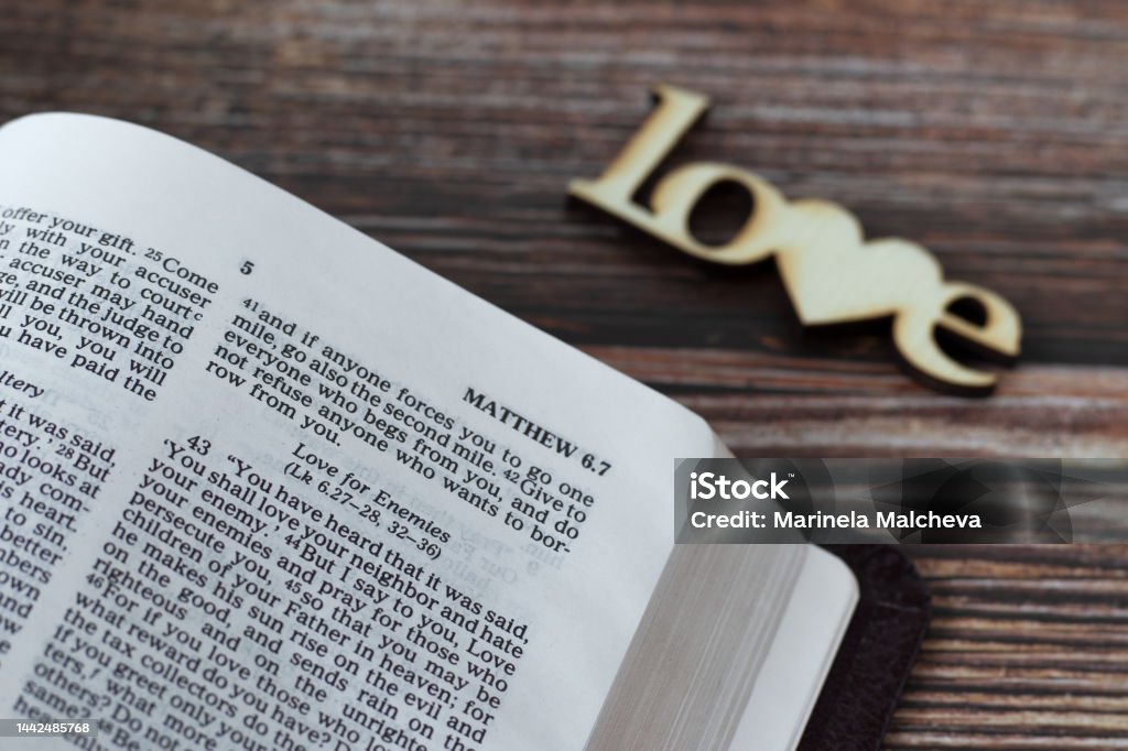 Love For Enemies Verse In Open Holy Bible Book On Wooden