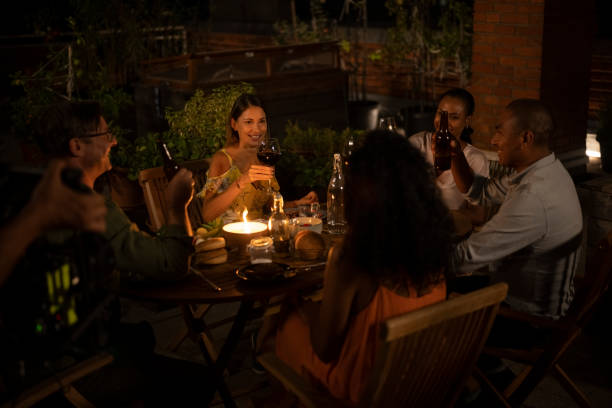 istock A group of friends toasting at dinner on the rooftop at night 1442486038